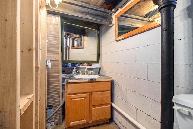 half bathroom featuring vanity and toilet