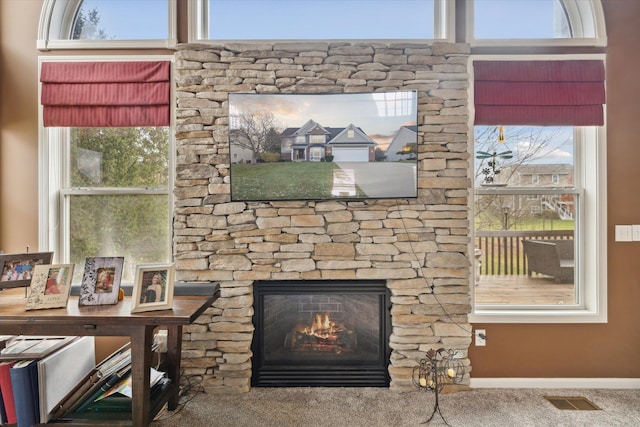 room details with a fireplace, visible vents, and baseboards