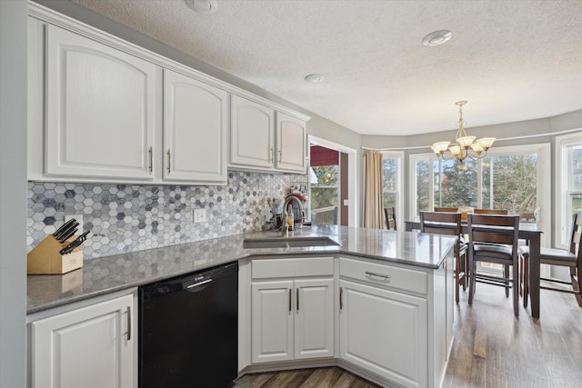 kitchen featuring dishwasher, light wood-style flooring, a peninsula, white cabinetry, and a sink