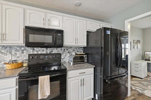 kitchen with backsplash, black appliances, wood finished floors, and white cabinetry