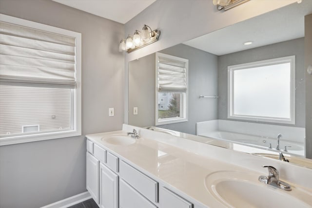 bathroom with a sink, baseboards, a garden tub, and double vanity