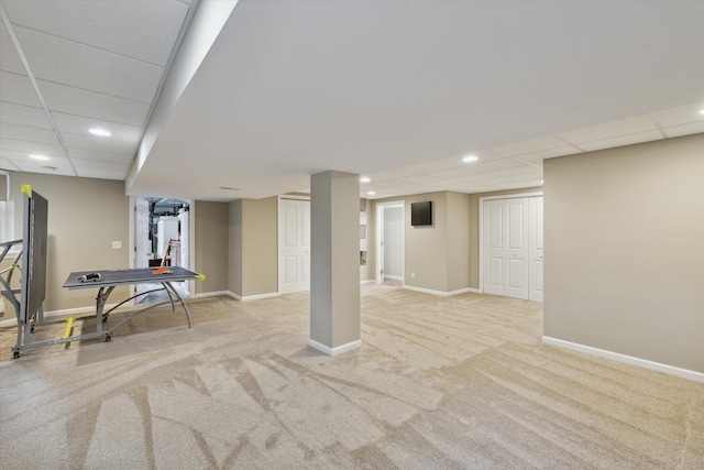 finished basement featuring recessed lighting, a paneled ceiling, baseboards, and carpet flooring