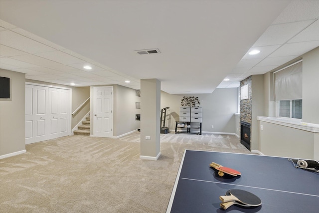 playroom with a stone fireplace, baseboards, visible vents, and carpet floors