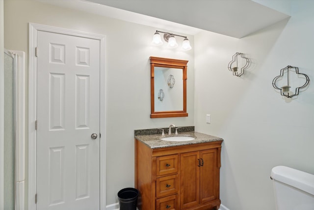 bathroom featuring toilet and vanity