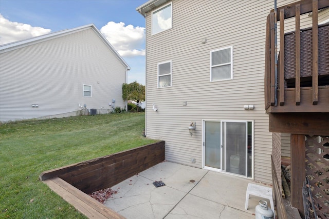 rear view of property featuring a lawn and a patio