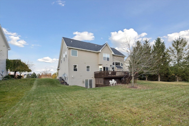 rear view of property featuring a yard, central air condition unit, a wooden deck, and stairway