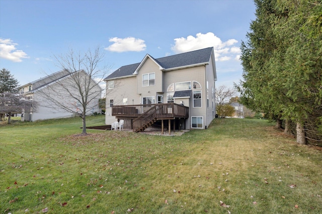 rear view of house with a lawn, a deck, and stairs