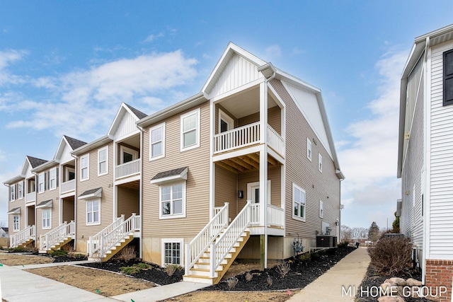 view of property with stairs and cooling unit