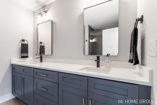 full bath featuring a sink, wood finished floors, and double vanity