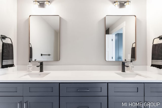 full bathroom with double vanity and a sink