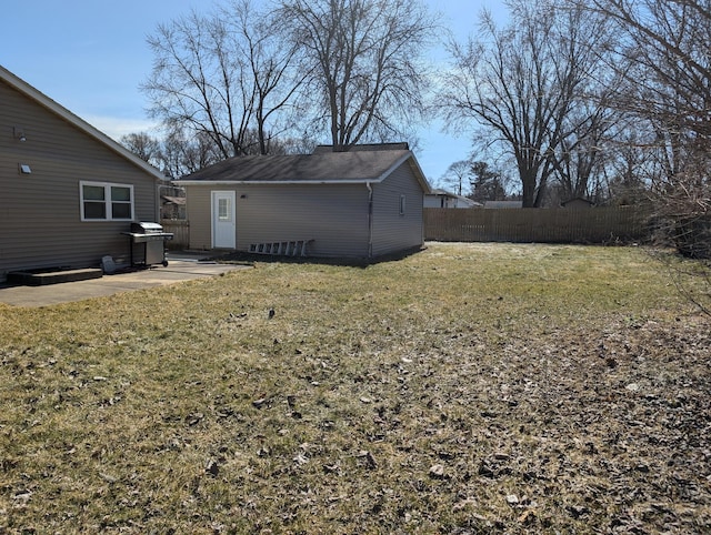 view of yard featuring a patio area, fence, and an outdoor structure