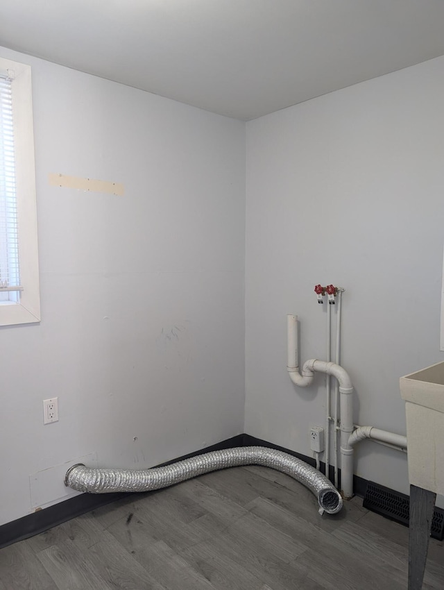 washroom with laundry area and wood finished floors