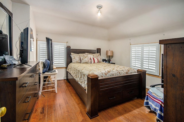 bedroom with baseboards and wood-type flooring