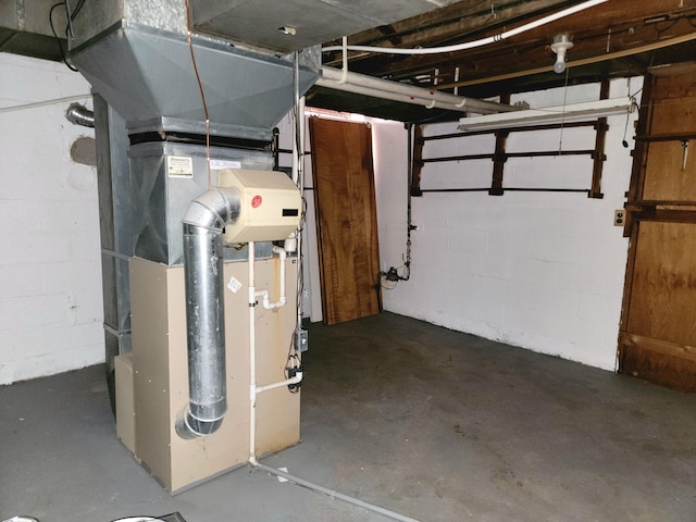 unfinished basement with heating unit and concrete block wall