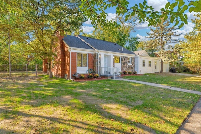 bungalow-style home featuring brick siding, roof with shingles, a front yard, and fence