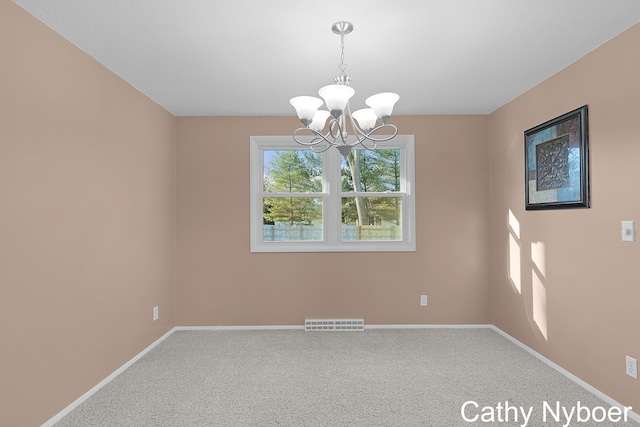 unfurnished room featuring a notable chandelier, carpet flooring, baseboards, and visible vents