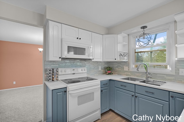 kitchen with white appliances, white cabinetry, open shelves, and a sink