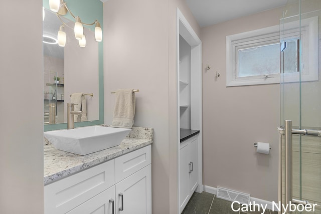 full bath with tile patterned flooring, visible vents, baseboards, an enclosed shower, and vanity