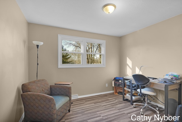 office space with baseboards and wood finished floors