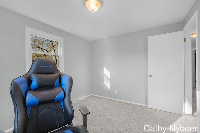 carpeted office featuring visible vents and baseboards