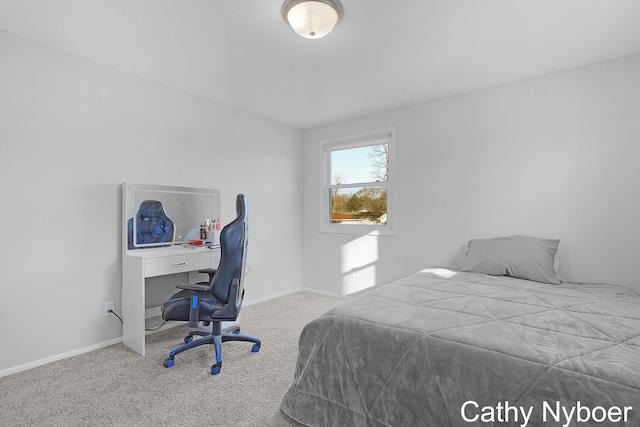 carpeted bedroom featuring baseboards