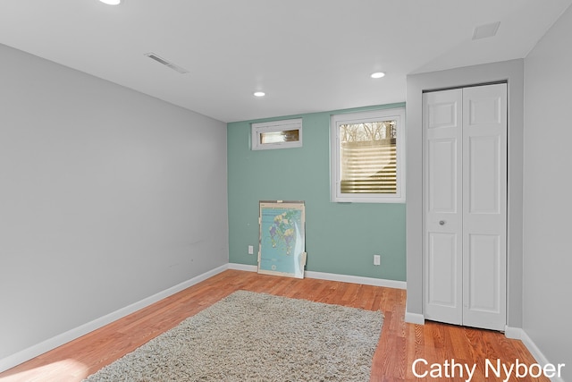 bedroom featuring visible vents, recessed lighting, baseboards, and wood finished floors