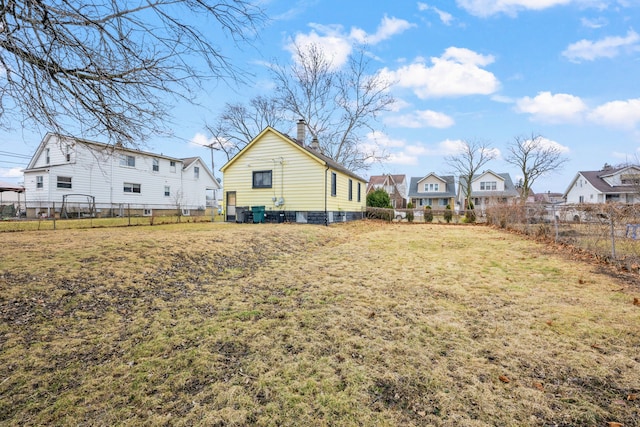 view of yard featuring a fenced backyard and a residential view