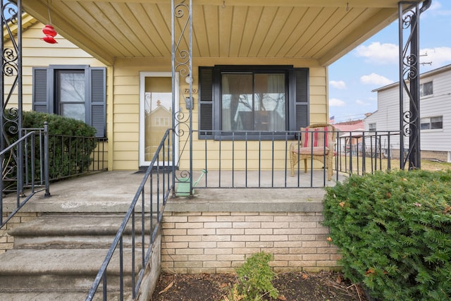 entrance to property featuring a porch