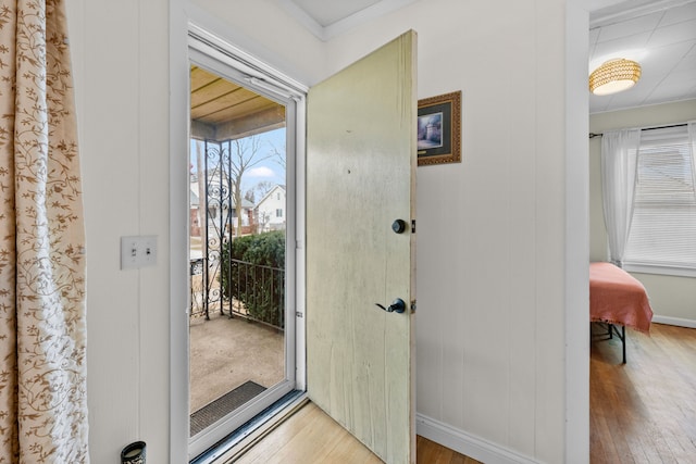 entryway with hardwood / wood-style floors and baseboards