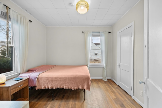 bedroom featuring baseboards and wood finished floors