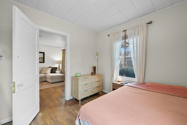 bedroom with dark wood-type flooring