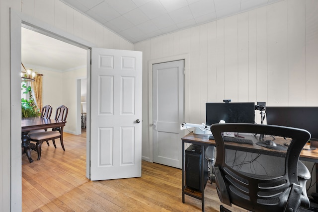 home office with light wood-style floors and a chandelier