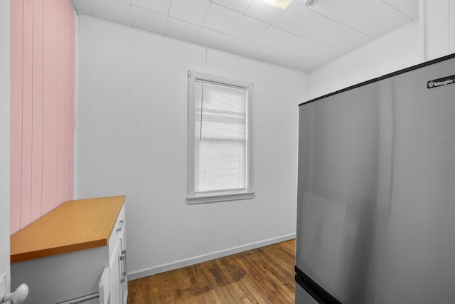 interior space featuring baseboards and dark wood-type flooring