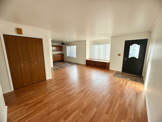 entryway featuring light wood-type flooring and ornamental molding