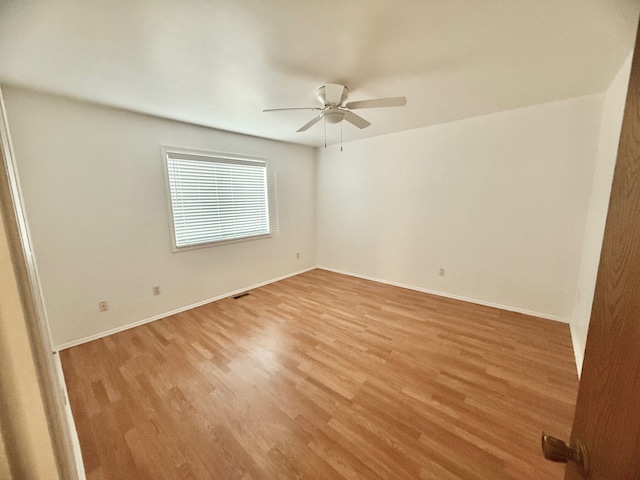 unfurnished room with visible vents, baseboards, light wood-type flooring, and a ceiling fan