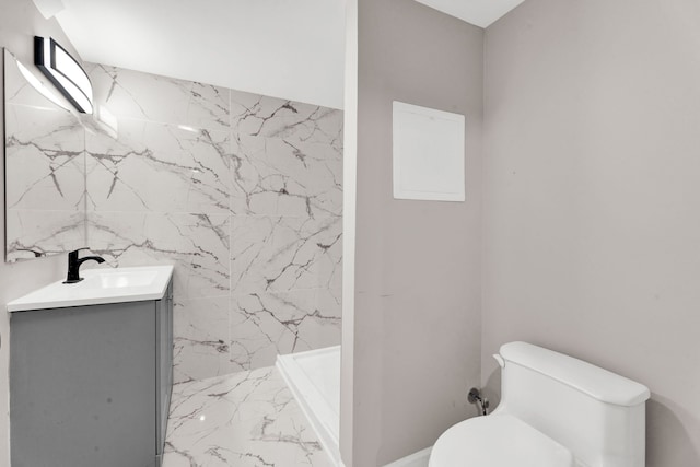 full bathroom featuring vanity, toilet, marble finish floor, and a shower stall