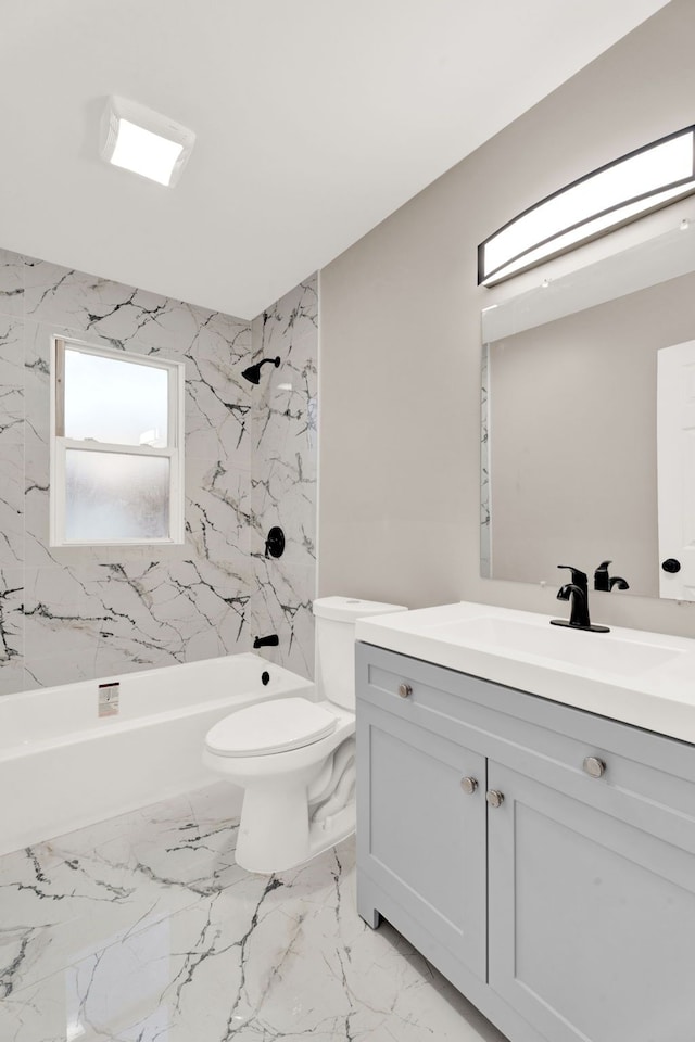 bathroom featuring vanity, toilet, marble finish floor, and shower / bathtub combination