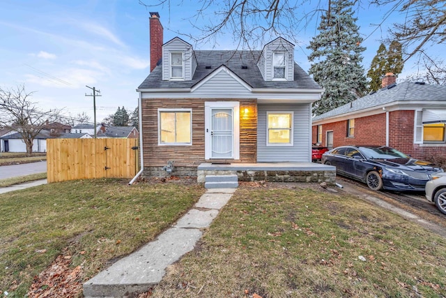 view of front of house featuring a front lawn, a porch, fence, and a chimney