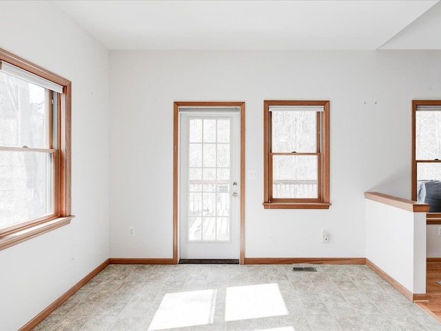 doorway with visible vents and baseboards