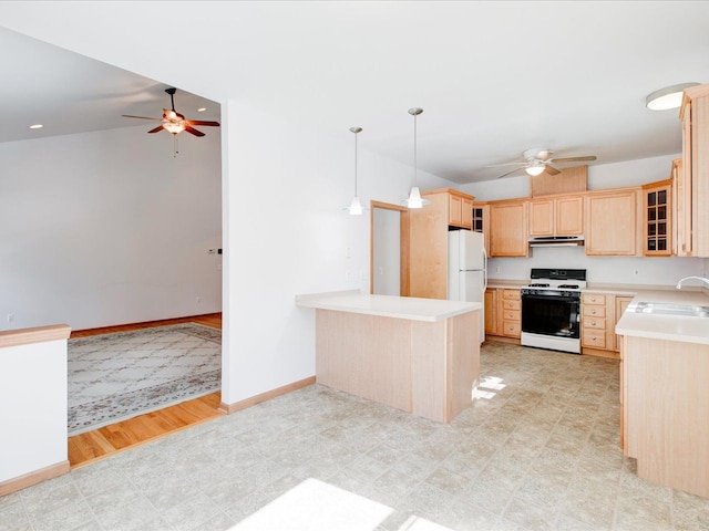 kitchen featuring light brown cabinetry, under cabinet range hood, a sink, white appliances, and light countertops