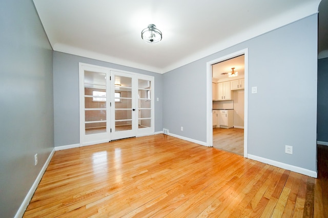 empty room with baseboards and wood finished floors