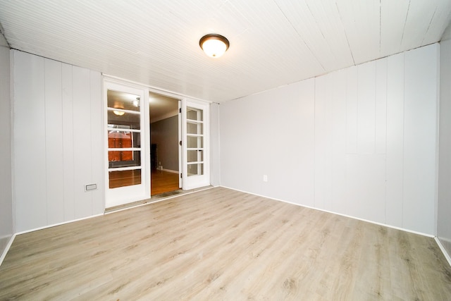 unfurnished room with french doors and wood finished floors