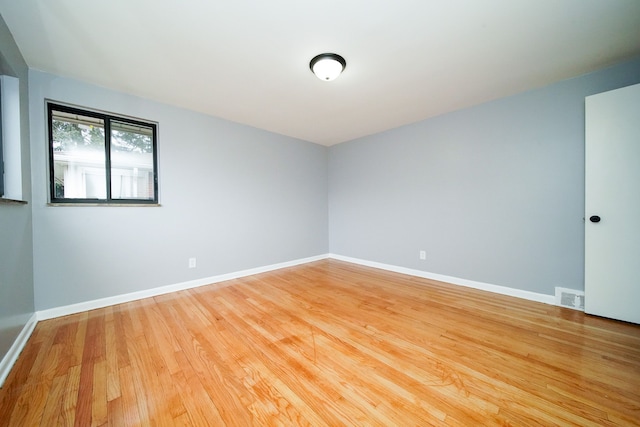 spare room with visible vents, baseboards, and light wood-style flooring