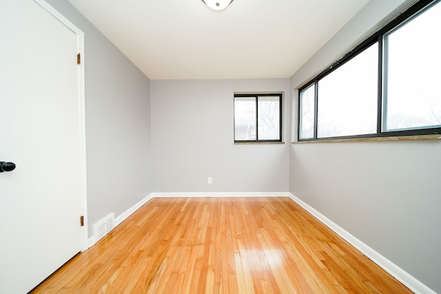 unfurnished room with visible vents, baseboards, and light wood finished floors