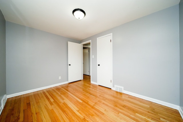 unfurnished room with visible vents, baseboards, and light wood-style floors