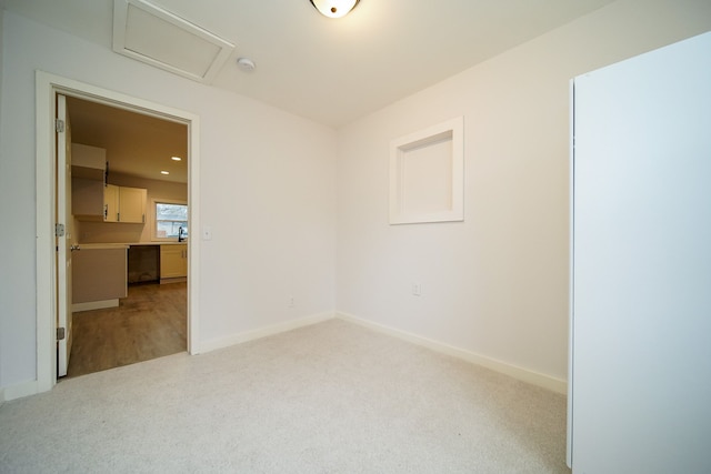 carpeted spare room with attic access, recessed lighting, and baseboards