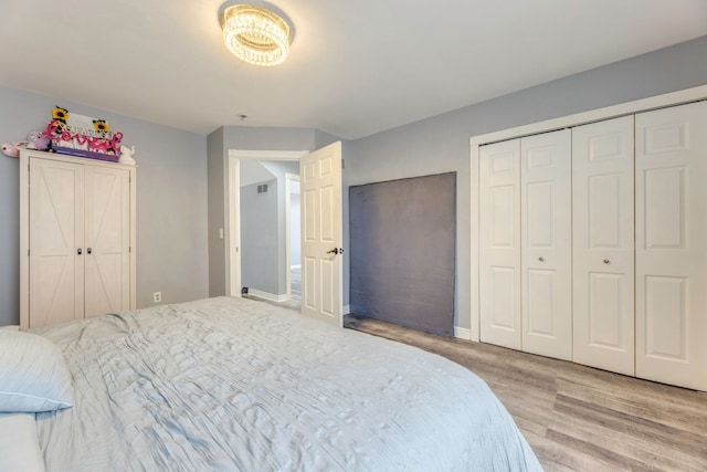 bedroom featuring a closet, baseboards, and wood finished floors