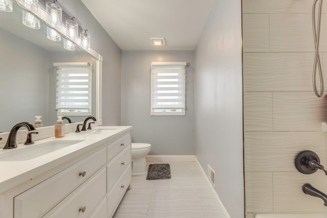 bathroom featuring a sink, visible vents, baseboards, and toilet