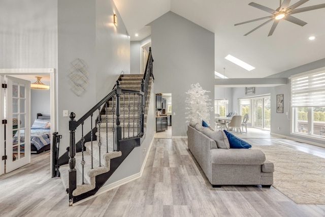 living area featuring stairway, wood finished floors, and french doors