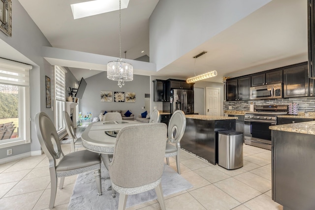 dining area with visible vents, baseboards, light tile patterned floors, an inviting chandelier, and high vaulted ceiling